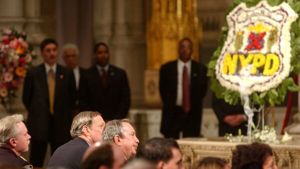 New York Mayor Michael Bloomberg (C) attends the funeral mass for police officer Moira Smith February 14, 2002 at St. Patricks Cathedral in New York City. Smith was one of 23 NYPD officers killed during the September 11, 2001 attacks on the World Trade Center.