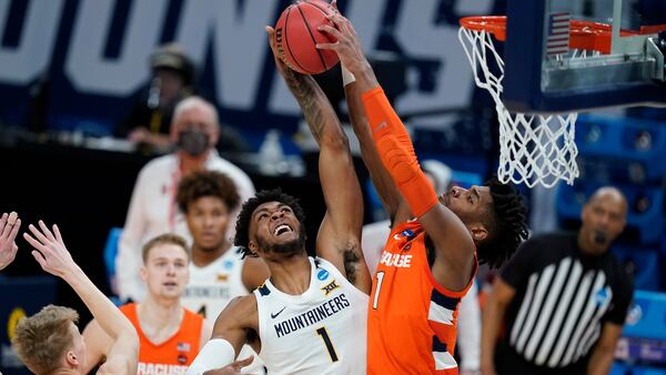 West Virginia's Derek Culver (1) has his shot blocked by Syracuse's Quincy Guerrier (1) during the first half of their second-round game in the NCAA Tournament Sunday, March 21, 2021, at Bankers Life Fieldhouse in Indianapolis. (Darron Cummings/AP)