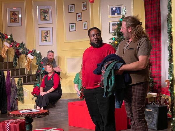 Narrator Topher Payne greets special guest Enoch King during a performance of "Y'allmark Christmas," as improvisers Amber Nash and Kevin Gillese watch from the steps.