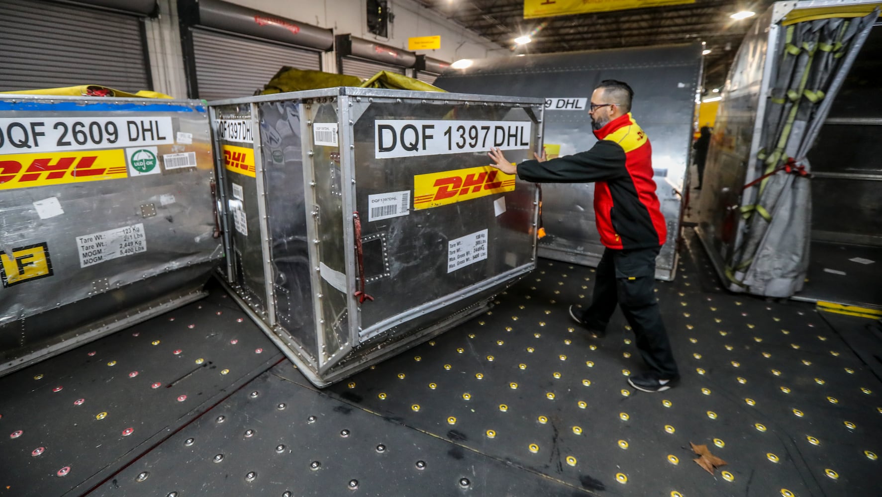 December 15, 2022 ATLANTA: Orlando Gonzalez moves plane cargo cartons into place.  (John Spink / John.Spink@ajc.com)

