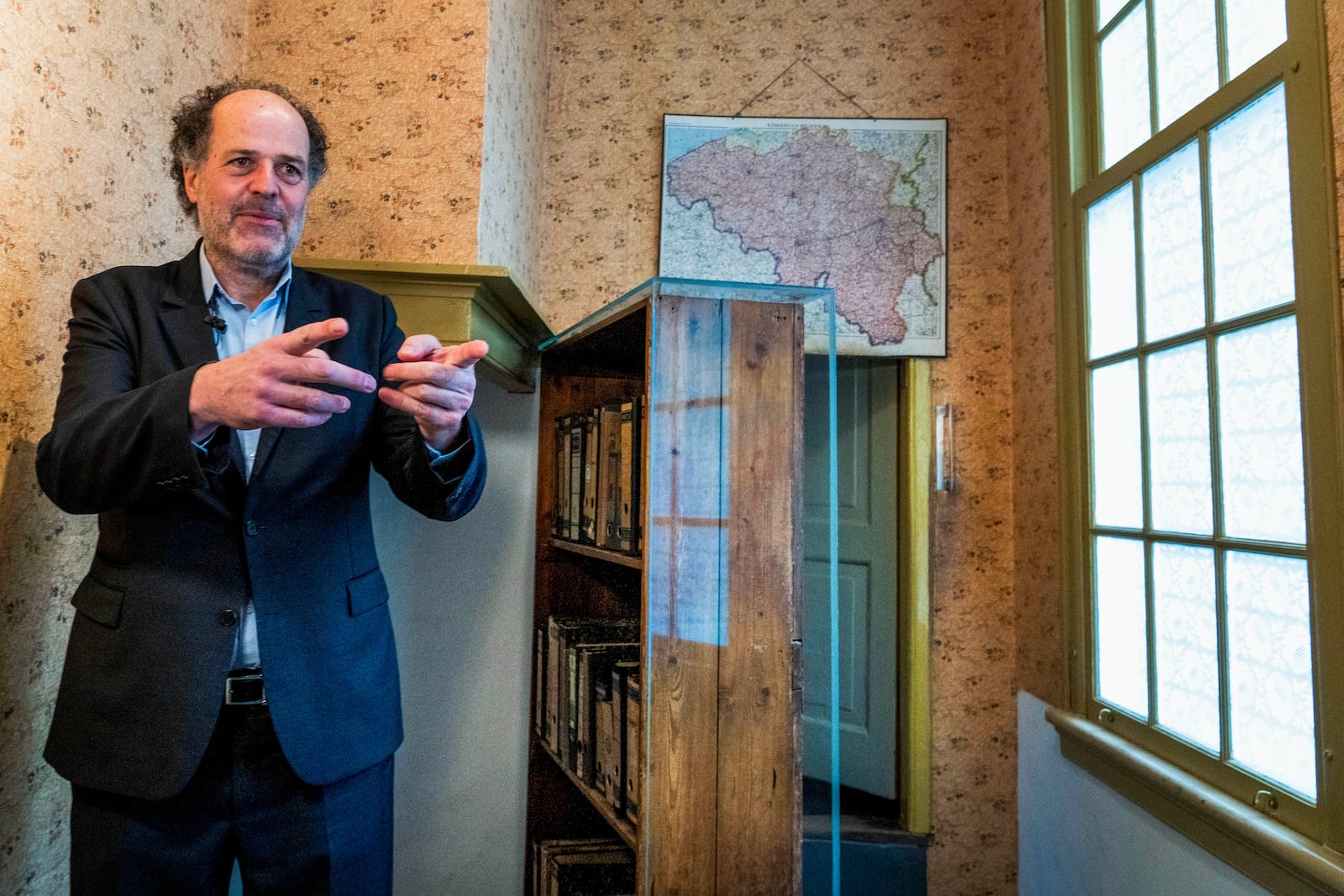 FILE - Ronald Leopold, executive director of the Anne Frank House, gestures as he talks next to the passage to the secret annex during an interview in Amsterdam, Netherlands, Monday, Jan. 17, 2022. (AP Photo/Peter Dejong, File)