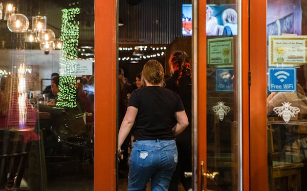 A patron enters Dark Side of the Moon, one of several bars that was busy in downtown Rome on a Friday night this month. (Christina Matacotta for The Atlanta Journal-Constitution)