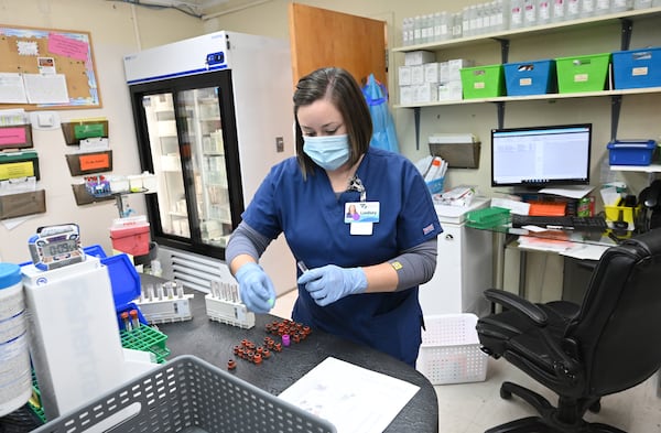 Lindsey Chambless, lab director, prepares testing kits. Testing and prevention help keep patients out of the ER and the hospital stay profitable, according to Chief Nursing Officer Shawn Whittaker. (Hyosub Shin / Hyosub.Shin@ajc.com)