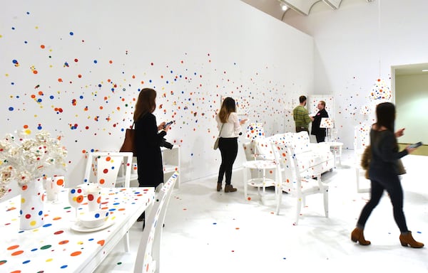 “The Obliteration Room” invites visitors to add their own two cents to the Yayoi Kusama exhibit at the High Museum, where one can place colored stickers on an all-white room. HYOSUB SHIN / HSHIN@AJC.COM