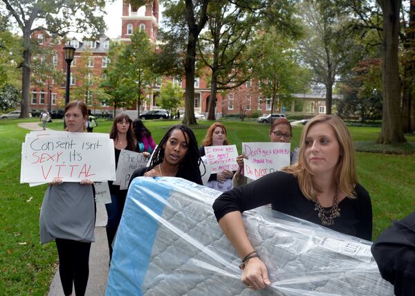 Agnes Scott College student Grace Starling, right, and fellow students carry a mattress around campus to show support for sexual assault victims as part of a national day of action, Carry That Weight Wednesday October 29, 2014. Some students carried mattresses to class with them in support of Columbia University student Emma Sulkowicz, who has carried a mattress around campus in protest after she alleged a male student raped her. BRANT SANDERLIN / BSANDERLIN@AJC.COM