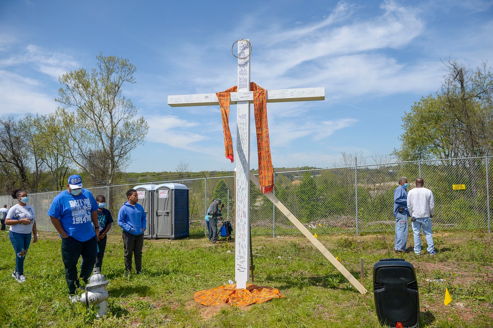 A Kente cloth, a traditional African garment, hangs on a cross that bears the names of victims who died while serving in the convict lease program at the Chattahoochee Brick Company. The event included a procession, prayers, libations, community testimonials, and site consecration Saturday, April 3, 2021, in Atlanta. (Photo: Daniel Varnado for The Atlanta Journal-Constitution)