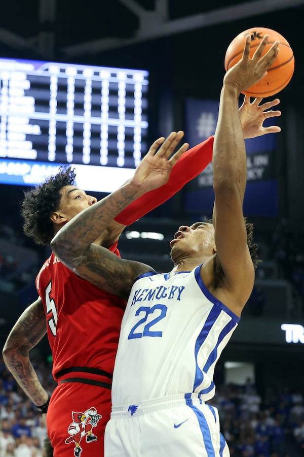 Kentucky's Amari Williams (22) is fouled by Louisville's Terrence Edwards Jr. (5) during the first half of an NCAA college basketball game in Lexington, Ky., Saturday, Dec. 14, 2024. (AP Photo/James Crisp)