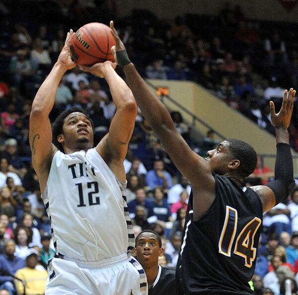 FOR 033014 hs boys poy STORY--MARCH 8, 2014 MACON Tift County Blue Devils Tadric Jackson #12 takes a shot over the defense of Wheeler Wildcats Elija Staley #14 during action in the first half. Coverage of the Class AAAAAA boys basketball championship between the Wheeler Wildcats and Tift County Blue Devils at the Macon Coliseum Saturday, March 8, 2014. Tift led 19-17 at the half. KENT D. JOHNSON / KDJOHNSON@AJC.COM Tadric Jackson, a Georgia Tech-bound guard who averaged nearly 25 points for his career until his senior season. (Kent D. Johnson / AJC)