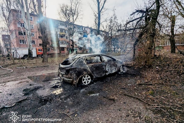 In this photo provided by the Ukrainian Emergency Service, a burned car and damaged residential buildings are seen after a Russian missile hit the area, in Kryvyi Rih, Ukraine, Wednesday, March 12, 2025. (Ukrainian Emergency Service via AP)