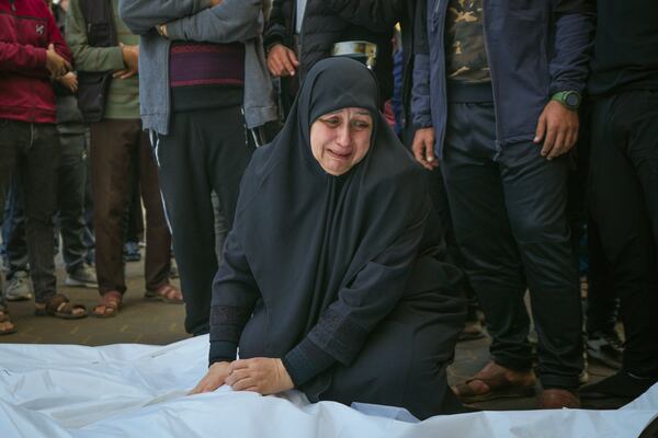 Asma Al Habash, mourns her brother and his family, victims of an Israeli army strike on the Nuseirat refugee camp, at the Al-Aqsa Martyrs hospital in Deir al-Balah, Gaza Strip, Thursday Dec. 12, 2024. Palestinian medical officials say Israeli airstrikes have killed at least 28 people in the Gaza Strip, including seven children and a woman. (AP Photo/Abdel Kareem Hana)