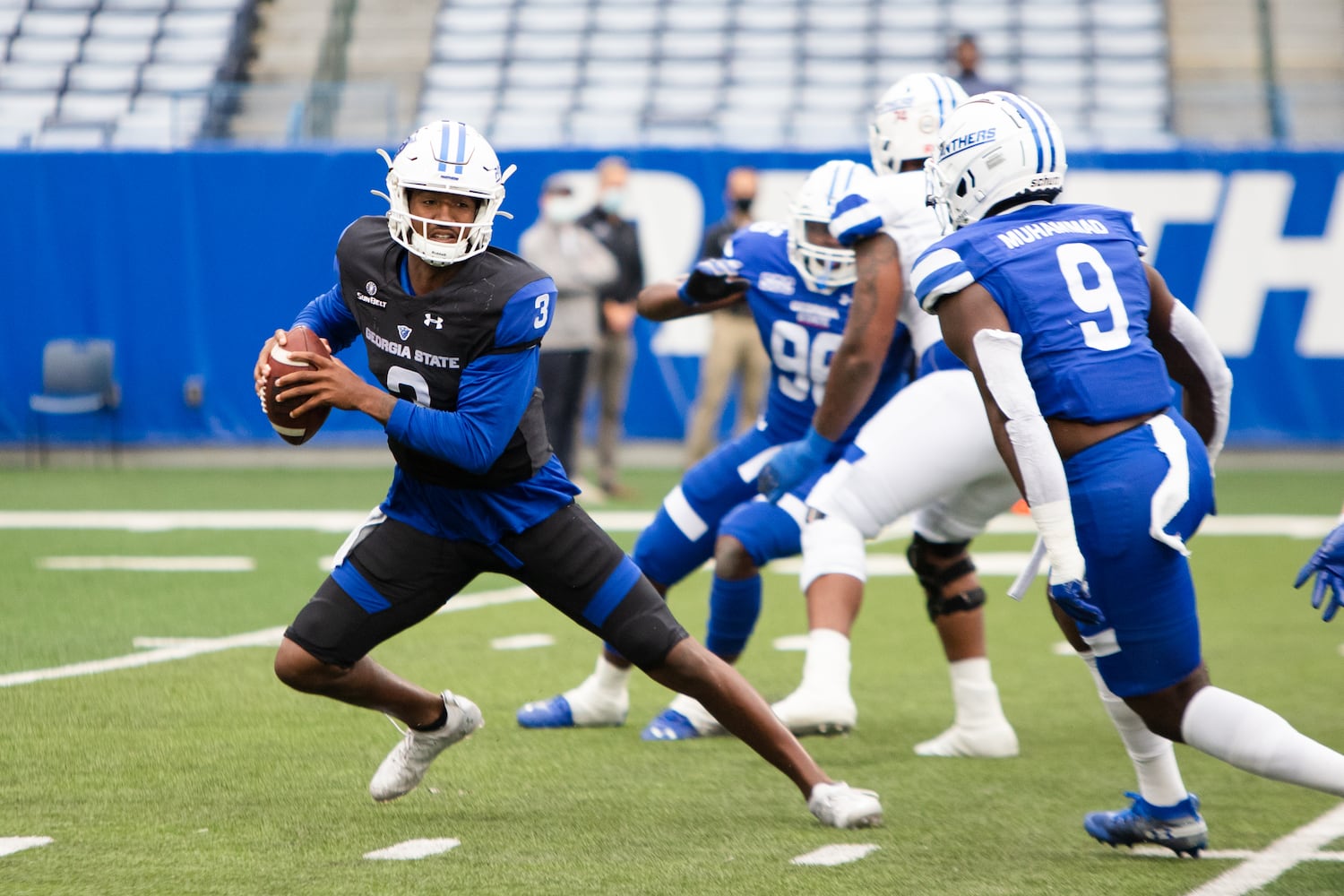 Darren Grainger (3), white team quarterback, scrambles in the pocket. CHRISTINA MATACOTTA FOR THE ATLANTA JOURNAL-CONSTITUTION