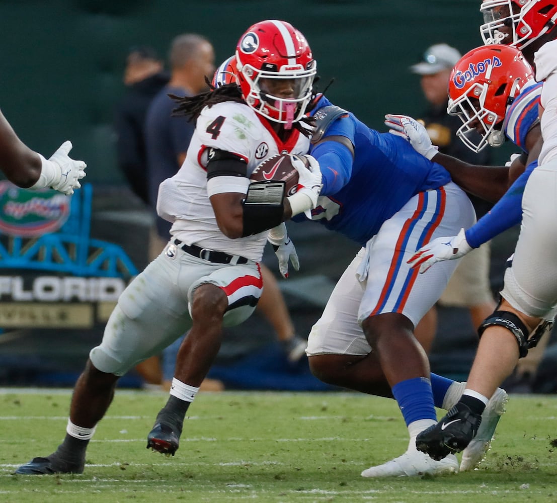 10/30/21 - Jacksonville -  Georgia Bulldogs running back James Cook (4) runs for a first down during the second half of the annual NCCA  Georgia vs Florida game at TIAA Bank Field in Jacksonville. Georgia won 34-7.  Bob Andres / bandres@ajc.com