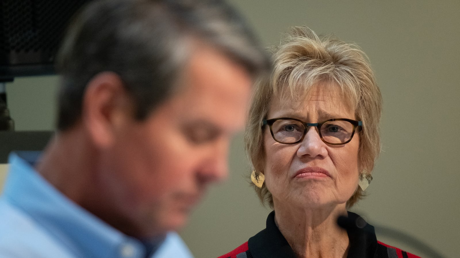 Dr. Kathleen Toomey, Georgia’s public health commissioner, watches Gov. Brian Kemp during a news conference Wednesday at the state Capitol about sheltering in place during the coronavirus pandemic. (Ben@BenGray.com for The Atlanta Journal-Constitution)