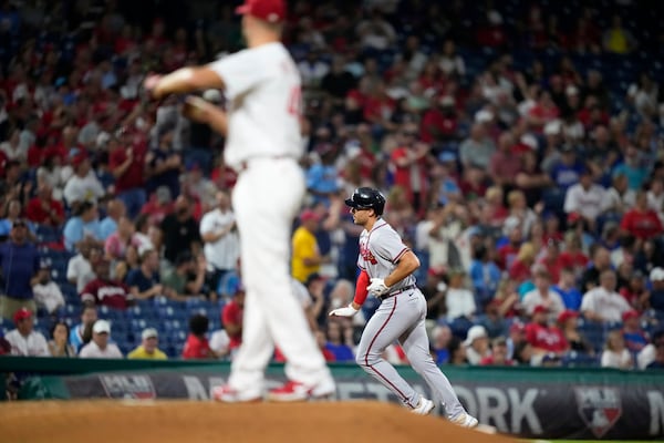 Atlanta Braves' Matt Olson, right, rounds the bases after hitting a home run against Philadelphia Phillies pitcher Zack Wheeler during the fourth inning of a baseball game, Tuesday, Sept. 12, 2023, in Philadelphia. (AP Photo/Matt Slocum)