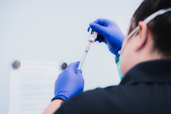 A healthcare worker prepares to administer the COVID-19 vaccine to Marietta City Schools employees. Credit: Natalie Roush/Marietta City Schools