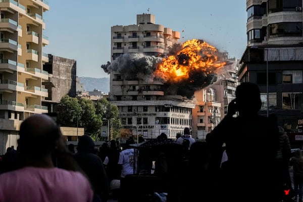 Smoke and flames erupt from a building hit by an Israeli airstrike in Chiyah, southern suburb of Beirut, Lebanon, Friday, Nov. 22, 2024. (AP Photo/Bilal Hussein)