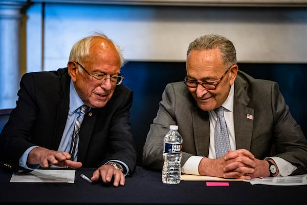 U.S. Senate Democratic Leader Chuck Schumer of New York, right, and Senate Budget Committee Chairman Bernie Sanders, D-Vt., helped push a $1.2 trillion infrastructure package through the chamber. (Samuel Corum/Getty Images/TNS)