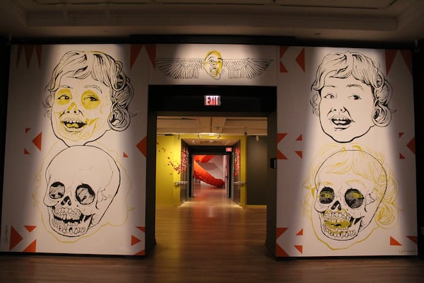 "Macabre by Design" by Egyptian artist Ganzeer (foreground) with work by Atlanta artist Amie Esslinger "Before the Hit" in the background.
Courtesy of the artists