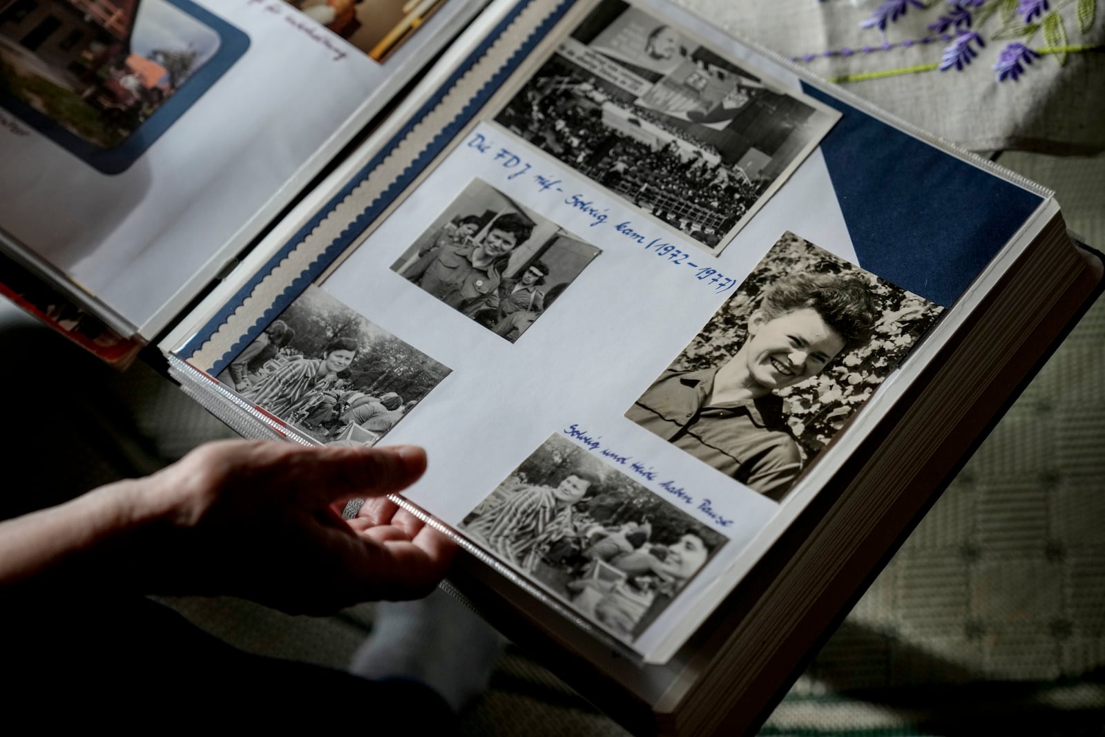 Solveig Leo, 81, former head of a large state-owned farm looks at her old photos album during her interview with the Associated Press in the northeastern village of Banzkow, Germany, Monday, Oct. 28, 2024. (AP Photo/Ebrahim Noroozi)