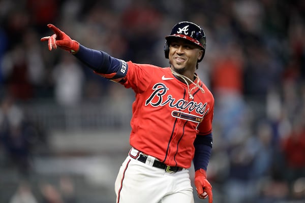 Atlanta Braves' Ozzie Albies celebrates after hitting a home run off Arizona Diamondbacks' Yoan Lopez during the seventh inning of a baseball game Friday, April 23, 2021, in Atlanta. (AP Photo/Ben Margot)