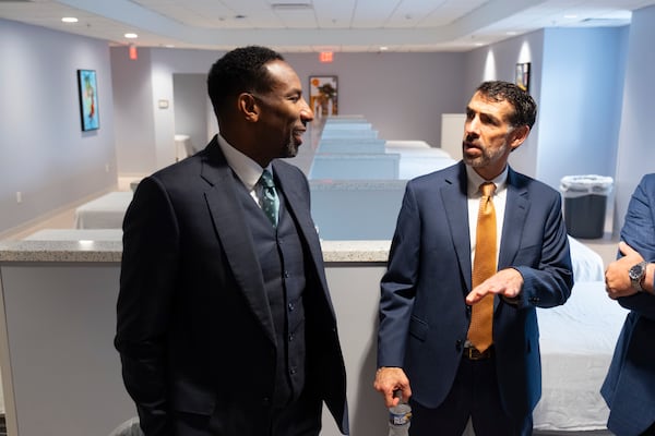 Mayor Andre Dickens and Superior Court Judge Robert McBurney talk in the bunk room of Atlanta’s new Center for Diversion and Services on Monday, Oct. 28, 2024, following a ribbon cutting ceremony. Ben Gray for the Atlanta Journal-Constitution