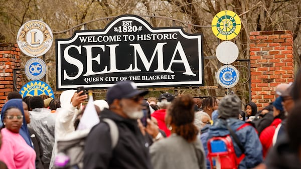 Attendees to the rally take pictures in front of the City of Selma sign during the 60th anniversary of Bloody Sunday, on Sunday, March 9, 2025. (Miguel Martinez/ AJC)