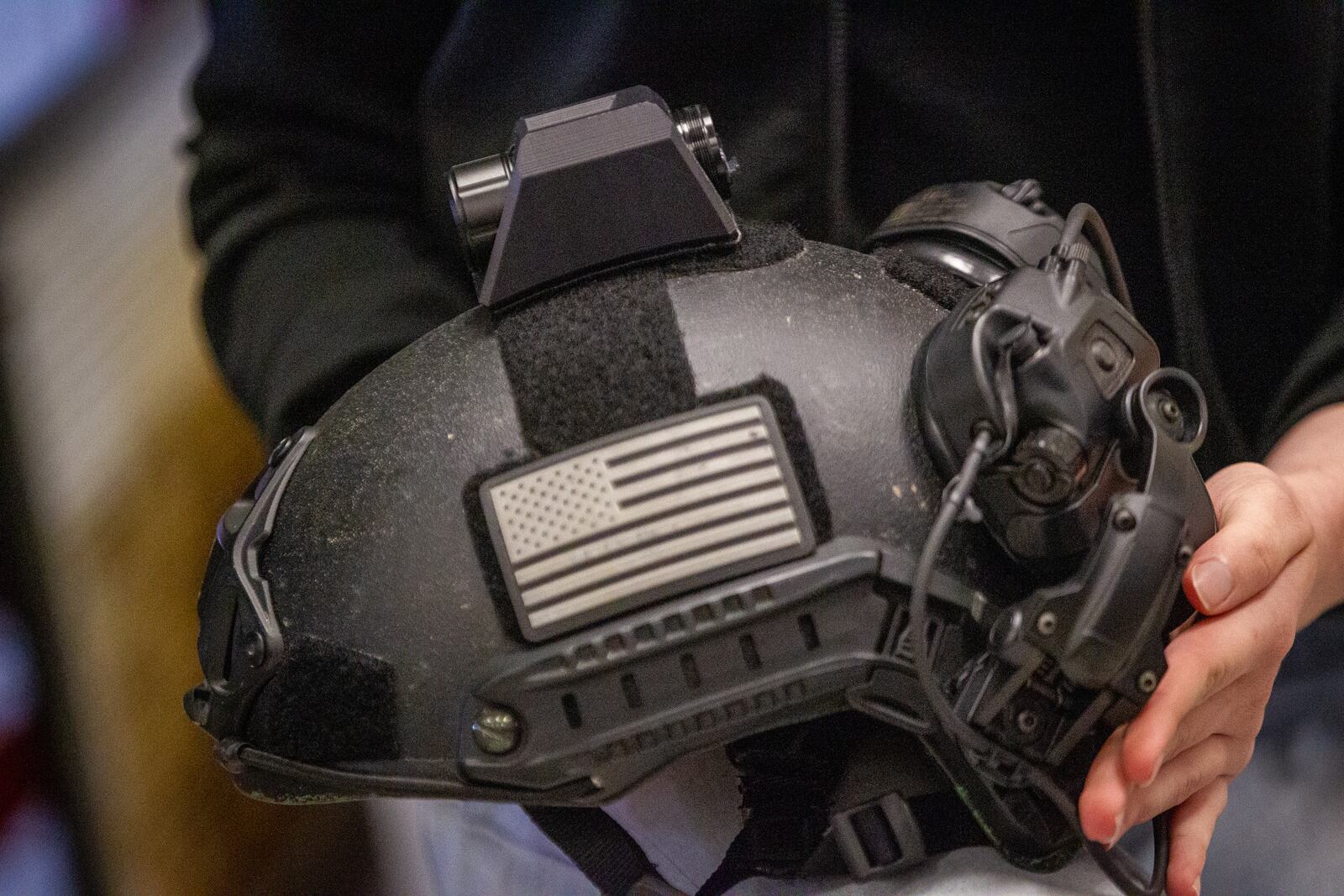 Senior Sarah Andrews holds a police helmet with her camera mount attached at Maxwell High School of Technology Thursday, March 17, 2022. (Steve Schaefer for The Atlanta Journal-Constitution)