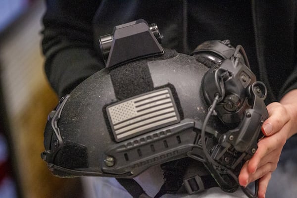 Senior Sarah Andrews holds a police helmet with her camera mount attached at Maxwell High School of Technology Thursday, March 17, 2022. (Steve Schaefer for The Atlanta Journal-Constitution)