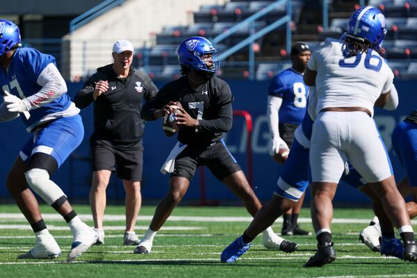 Georgia State quarterback Braylen Ragland (7) attempts a pass as head coach Shawn Elliott, second from left, watches during the first day of spring football practice at Center Parc Stadium, Tuesday, February 13, 2024, in Atlanta. (Jason Getz / jason.getz@ajc.com)