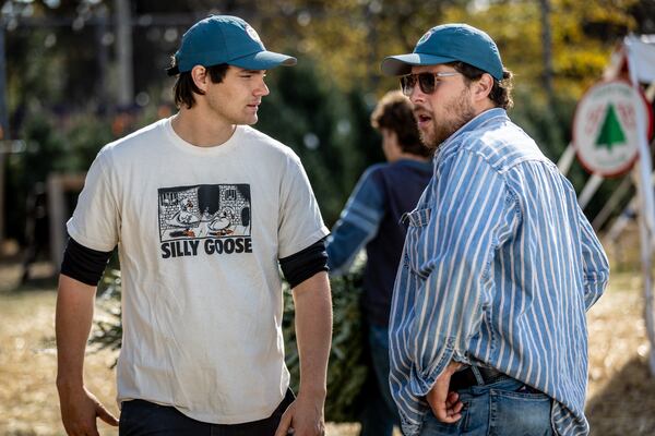 Owners Jack Faught (Left) and Calder Johnson talk during a slow moment at their Trees For Tuition Christmas tree lot in Virginia Highland on Saturday, November 25, 2023. (Steve Schaefer/steve.schaefer@ajc.com)