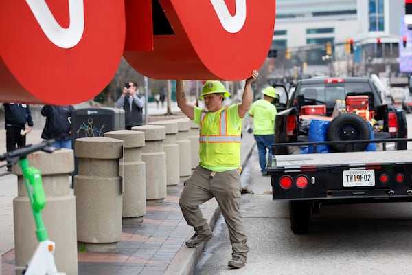 A crew worker is seen helping direct the 12-foot, red-and-white CNN sign to a flatbed truck after being removed from its base, CNN Center, on Monday, March 2024. The famous symbol will be refurbished and will find its new home at the Techwood campus by the Warner Brothers studios in Midtown.
Miguel Martinez /miguel.martinezjimenez@ajc.com