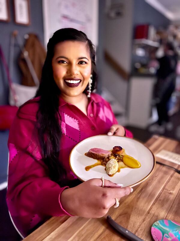 Uma Chidambaram shows off a dish from a recent Speak Easy Supper Club dinner in Marietta. She has attended at least 35 dinners. Courtesy of Teresa Bishop