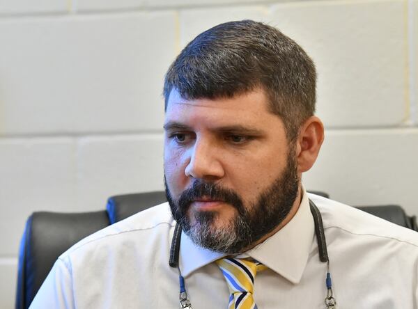 Greer Smith, principal of Jeff Davis High School, pauses as he speaks Monday about his experience battling COVID-19. The 38-year-old's life was in the balance as a doctor and nurses at the Hazlehurst hospital called scores of bigger health care systems, trying to get him accepted at one with the equipment that could allow his battered lungs to heal. (Hyosub Shin / Hyosub.Shin@ajc.com)