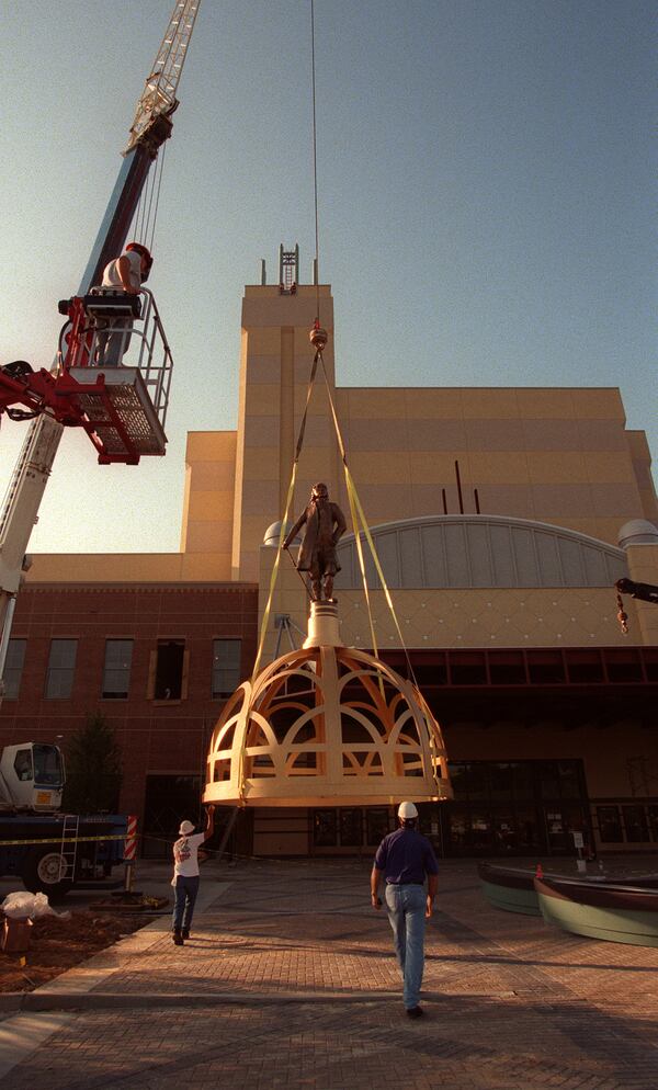 A 12-foot statue of Button Gwinnett was placed on top of the Mall of Georgia in July 1999. FILE PHOTOS