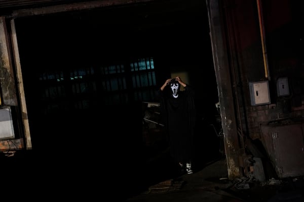 A visitor dressed in a ghost costume at Goosebump market as a part of Halloween festival in Bangkok, Thailand, Wednesday, Oct. 30, 2024. (AP Photo/Sakchai Lalit)