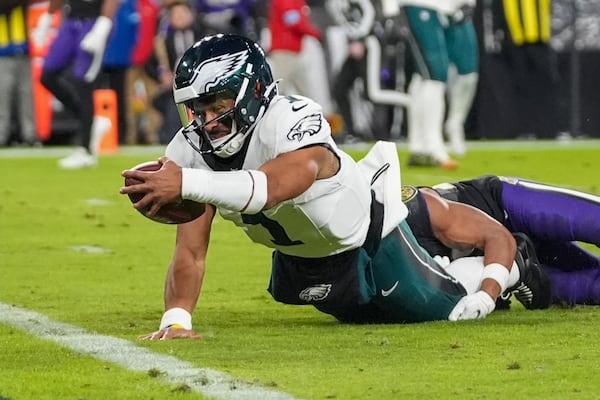 Philadelphia Eagles quarterback Jalen Hurts tries to stretch to score on a keeper against the Baltimore Ravens during the first half of an NFL football game, Sunday, Dec. 1, 2024, in Baltimore. (AP Photo/Stephanie Scarbrough)