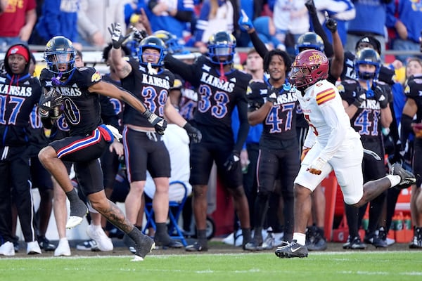 Kansas wide receiver Quentin Skinner (0) is chased by Iowa State defensive back Myles Purchase (5) as he runs for a first down during the first half of an NCAA college football game Saturday, Nov. 9, 2024, in Kansas City, Mo. (AP Photo/Charlie Riedel)