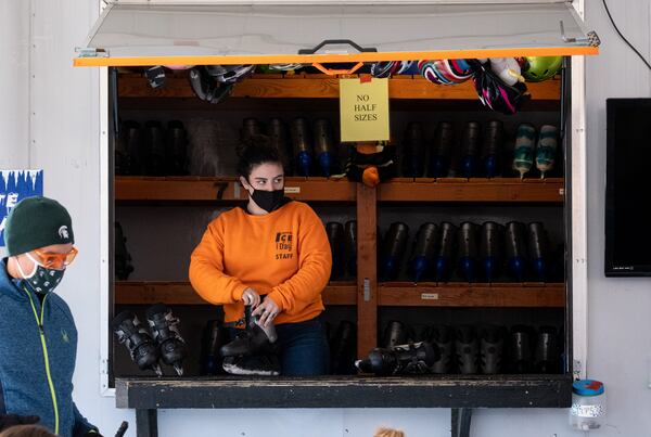 Ana Motherwell works the skate rental counter at the Have an Ice Day rink in downtown Sugar Hill on Saturday afternoon, December 26, 2020. Pandemic precautions were in effect at the largest portable ice-skating rink in the Southeast. (Photo: Ben Gray for The Atlanta Journal-Constitution)