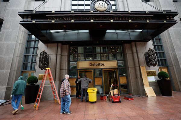 Cleaning personnel remove debris from broken doors and windows at 191 Peachtree Tower in downtown Atlanta on Sunday, January 22, 2023. The damage came in the wake of violent protests the night before against a proposed police training center. (Photo: Miguel Martinez / miguel.martinezjimenez@ajc.com)