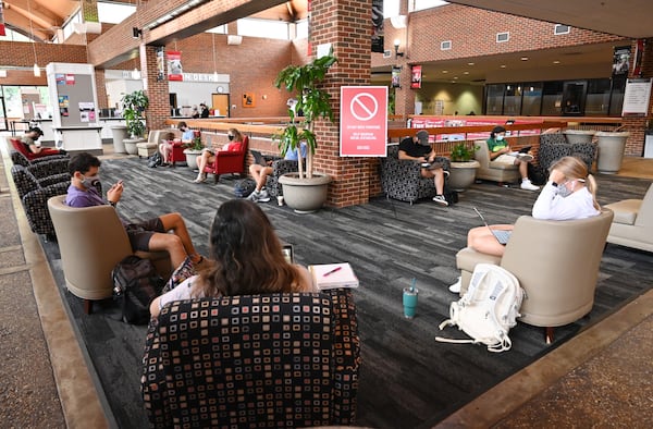 Students sit inside Tate Student Center while socially distanced and wearing protective face masks as the University of Georgia starts classes for the fall semester on Thursday, Aug. 20, 2020. (Hyosub Shin / Hyosub.Shin@ajc.com)