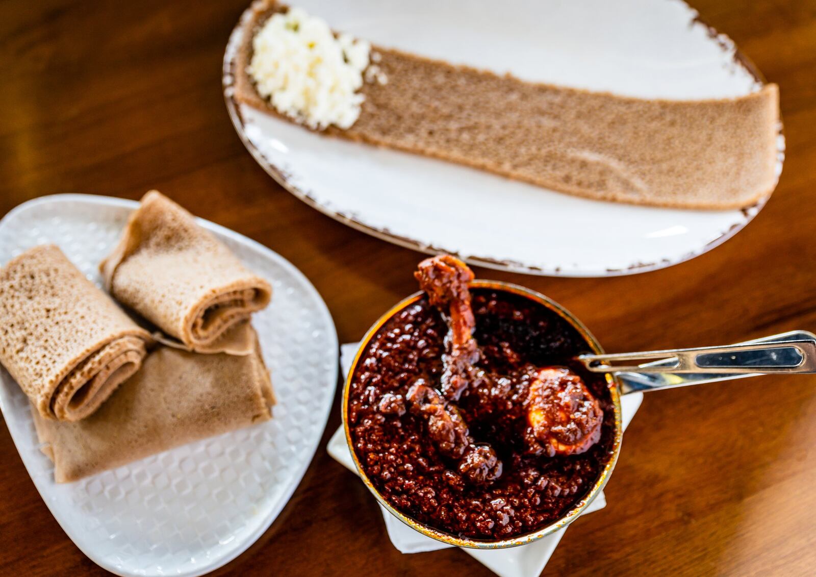 Doro wat, a traditional spicy stew that includes a tender chicken leg and a hard-boiled egg, is shown with injera at Feedel Bistro. CONTRIBUTED BY HENRI HOLLIS