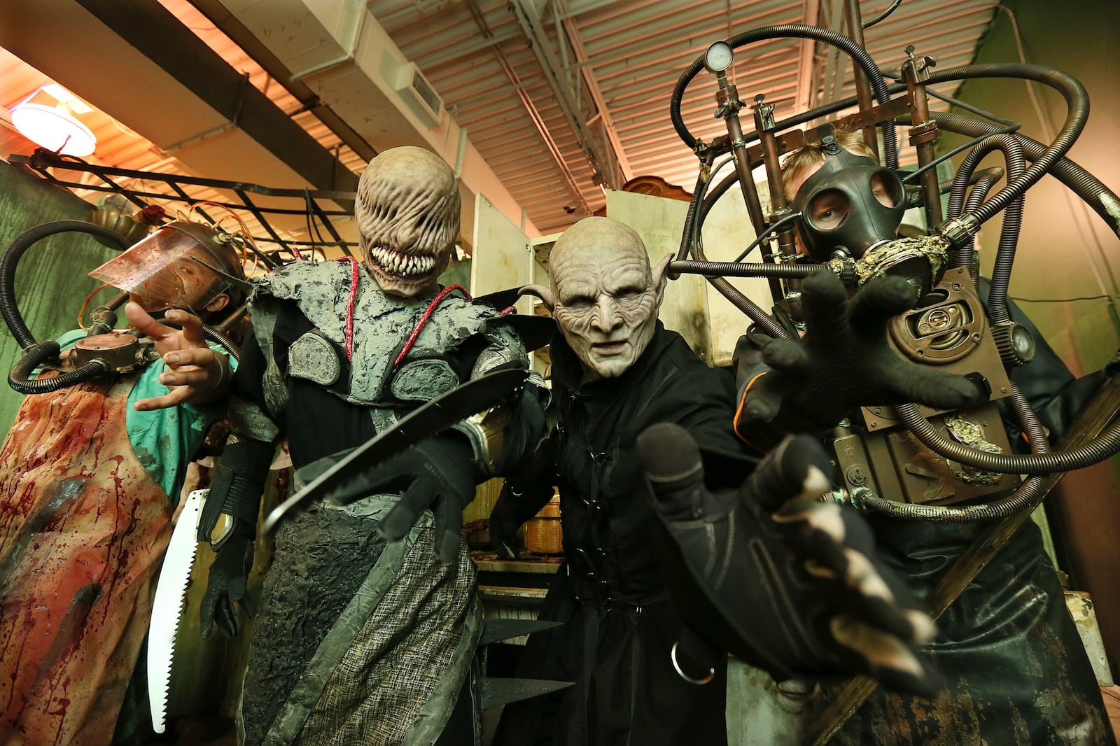 Nestor Montes (from left), Jacob Peterson, co-owner Dave Leikam, and Daniel Kempson play some of the spooky characters waiting for those that enter the Paranoia Haunted House. CURTIS COMPTON / CCOMPTON@AJC.COM