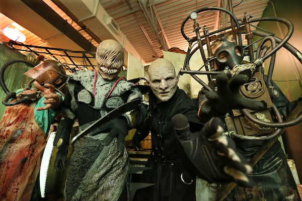 Nestor Montes (from left), Jacob Peterson, co-owner Dave Leikam, and Daniel Kempson play some of the spooky characters waiting for those that enter the Paranoia Haunted House. CURTIS COMPTON / CCOMPTON@AJC.COM