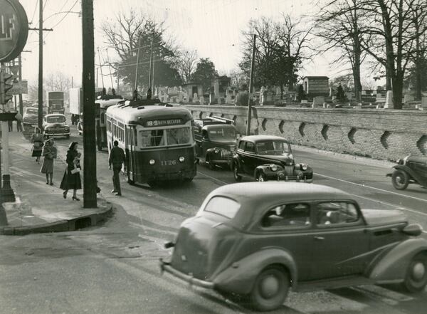 In 1949, Oakland Cemetery appears a peaceful refuge on the other side of its brick exterior wall, especially as compared to busy Memorial Drive, with its trolley, car and truck traffic. (File Photo) 