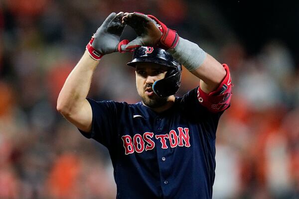 Boston Red Sox's Adam Duvall gestures after hitting a triple against the Baltimore Orioles during the second inning of a baseball game, Saturday, Sept. 30, 2023, in Baltimore. (AP Photo/Julio Cortez)