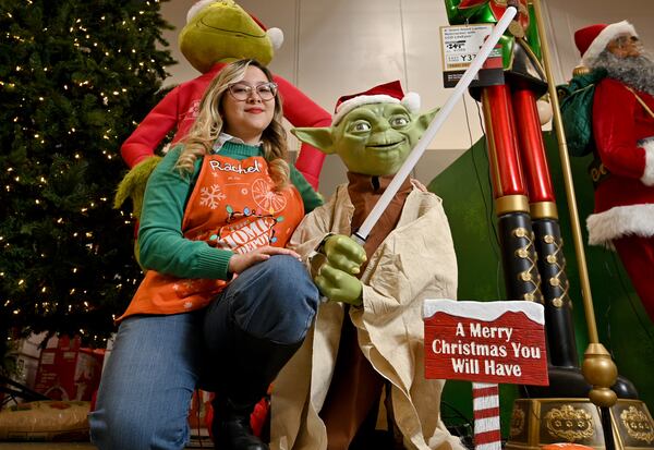 Rachel Little, a Star Wars fan, is pictured here with Yoda, one of the most popular characters of the action movie series. (Hyosub Shin / Hyosub.Shin@ajc.com)