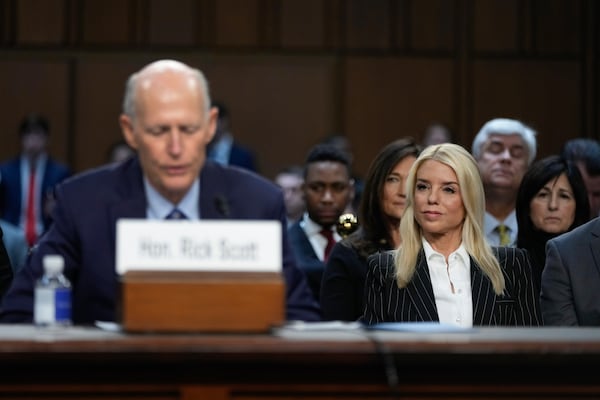 Pam Bondi, right, President-elect Donald Trump's choice to lead the Justice Department as attorney general, listens to Sen. Rick Scott, R-Fla., left, at the Senate Judiciary Committee for her confirmation hearing, at the Capitol in Washington, Wednesday, Jan. 15, 2025. (AP Photo/Ben Curtis)