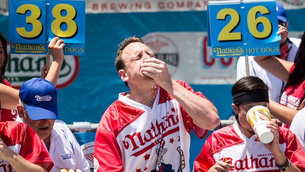 Joey Chestnut (C) and Matt Stonie (R) compete in the 2017 Nathan's Famous International Hot Dog Eating Contest at Coney Island on July 4, 2017 in the Brooklyn borough of New York City. Chestnut was declared the winner for this 10th title overall after eating 72 hot dogs in 10 minutes. The contest in Coney Island is in it's 101th year. (Photo by Alex Wroblewski/Getty Images)