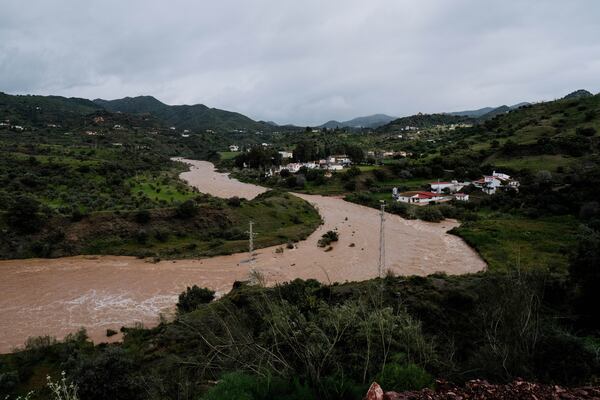 Water flows down the swollen river after the release of water from the dam of Casasola in Malaga, Spain, Tuesday, March 18, 2025.(AP Photo/Gregorio Marrero)