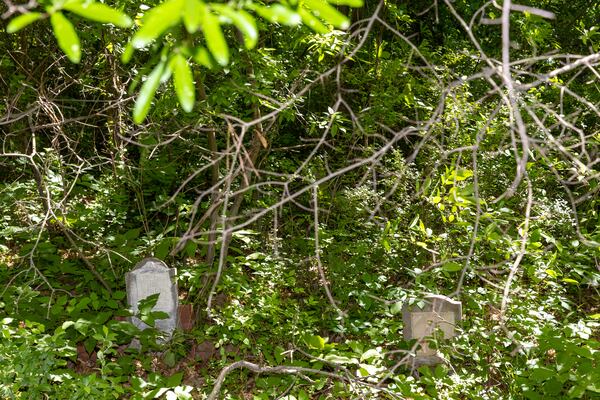 Gravestones in Piney Grove Cemetery in Buckhead on Wednesday, May 3, 2023. Audrey Collins and her sister Rhonda Jackson are trying to restore the ancient cemetery, which is where about 30 of their family members are buried. (Arvin Temkar / arvin.temkar@ajc.com)